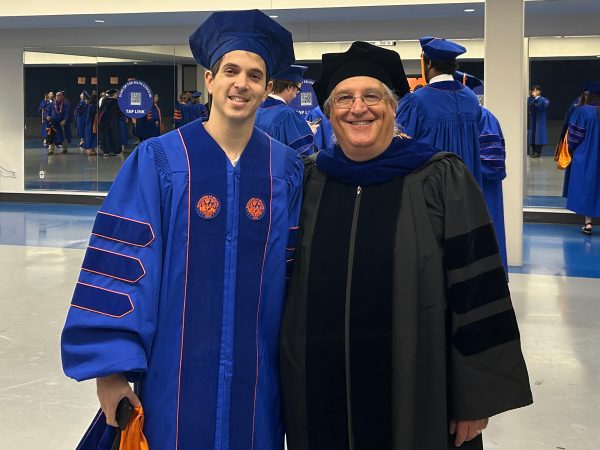 two men in graduation robes and caps
