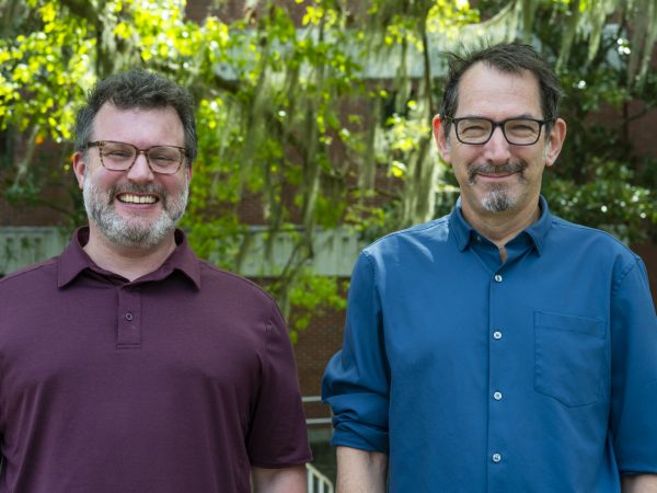 David Blackburn and Robert Guralnick standing side by side, smiling at the camera
