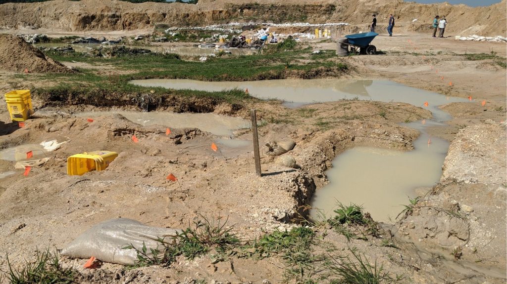 dig site with many deep puddles