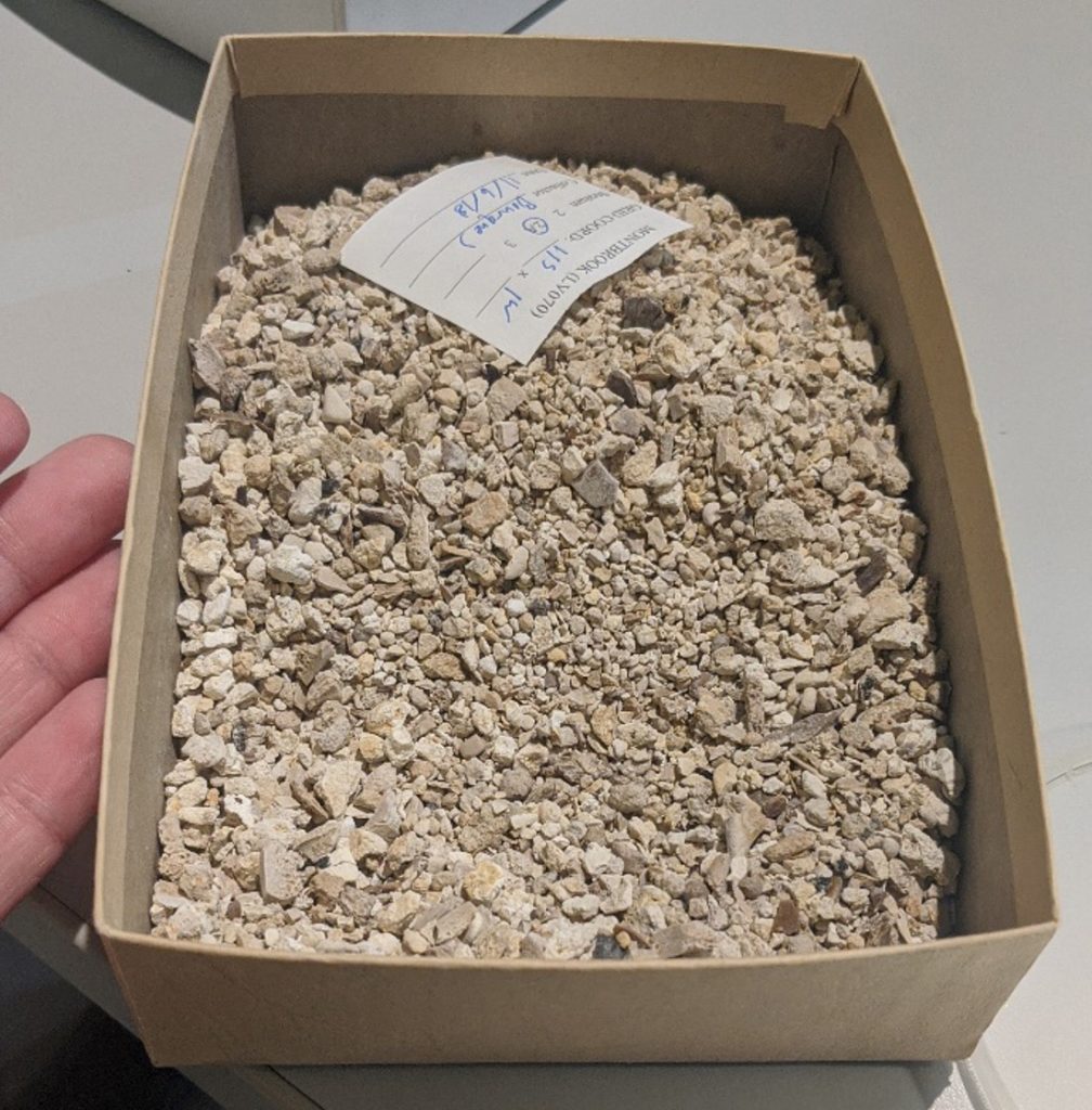 box of sediment with a label in the sediment