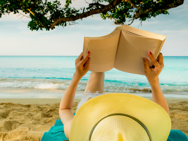 woman reading on the beach